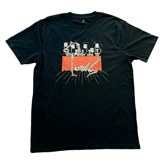 black unisex t-shirt with two skeletons doing different voguing poses associated from the New York ballroom scene. there is a judges table behind them where all the skeleton judges are scoring them 10