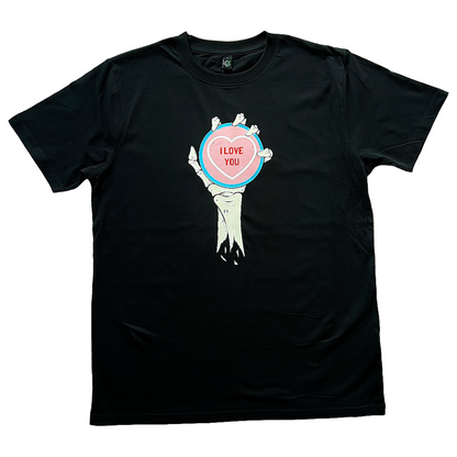 black unisex t-shirt of a skeleton hand and forearm holding an oversized love heart candy that reads I Love You on it. the colours of the candy are in the colours of the transgender flag